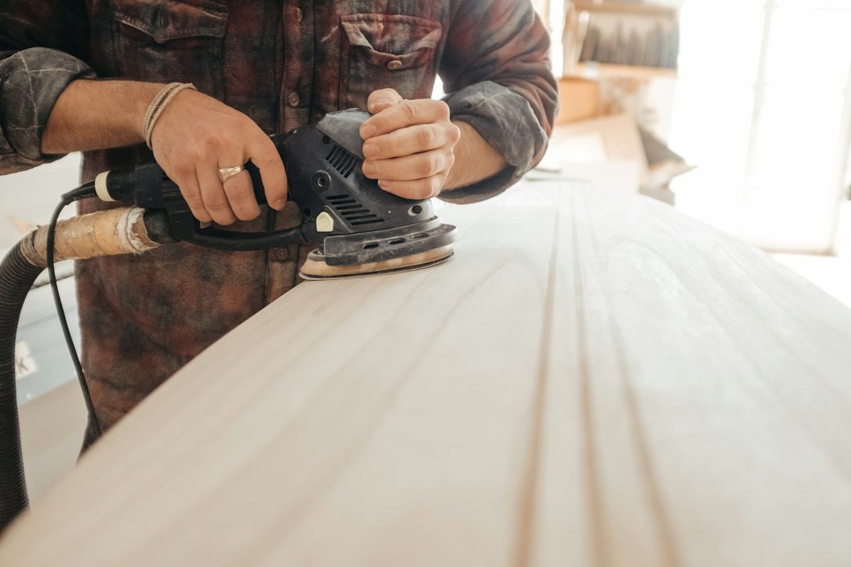 Sanding a wood surface smooth before finishing